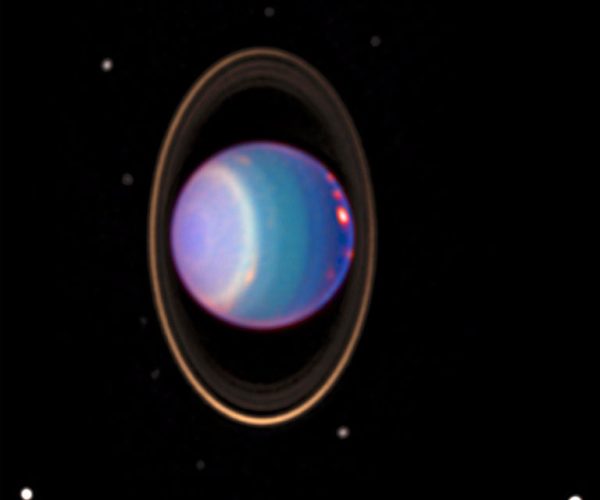 Uranus is surrounded by its four major rings and 10 of its 27 known moons in this color-added view that uses data taken by the Hubble Space Telescope in 1998. A study featuring new modeling shows that four of Uranus’ large moons likely contain internal oceans.. (Photo:  NASA/JPL/STScI)