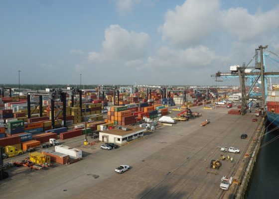 Houston container terminal with green gantry cranes, operated by stevedores who are ready for loading operation. There are behind stevedoring containers from different shippers. (Photo: ©Jan Gajdosik
| Dreamstime.com)