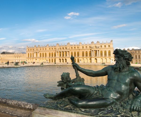 Pond with statue and Palace Versailles in France. (Photo: © Peter Apers/Dreamstime.com)